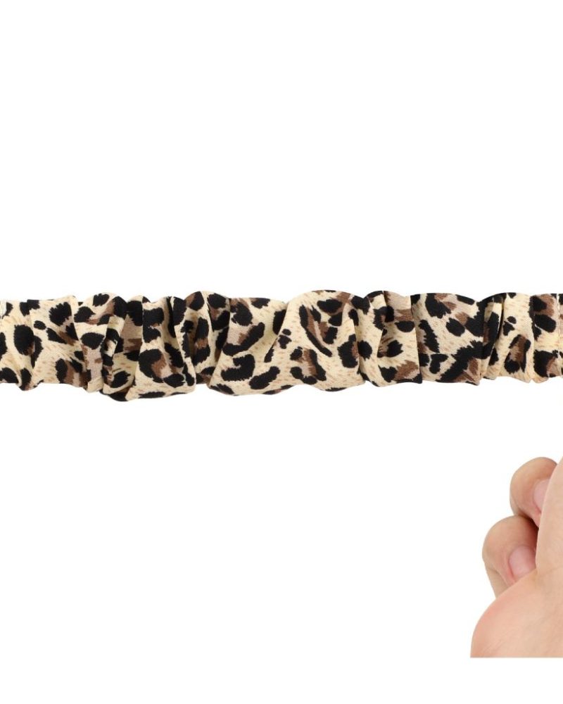 Cheetah print scrunchie elastic fabric Apple Watch band stretched between hands