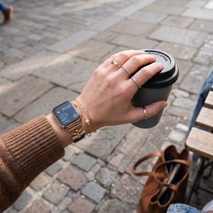 Model wearing Dakota Hybrid Steel Leather Band for Apple Watch in Gold and Black Leather Apple Watch band
