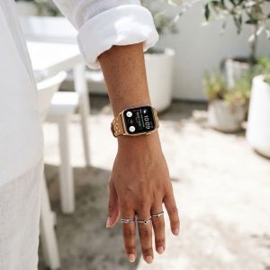Model wearing Elektra Leather Band with Gold Rivets for Apple Watch in Brown Apple Watch band
