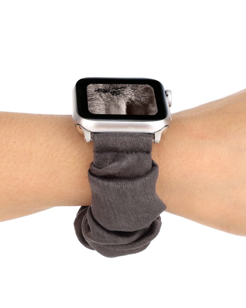 Grey scrunchie fabric Apple Watch band worn on a wrist