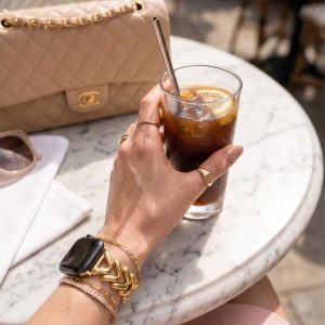Model wearing Herringbone Stainless Steel Band for the Apple Watch in Gold Apple Watch band