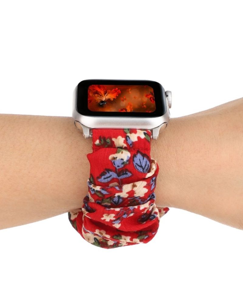 Red floral scrunchie loop band for Apple Watch on wrist, silver case