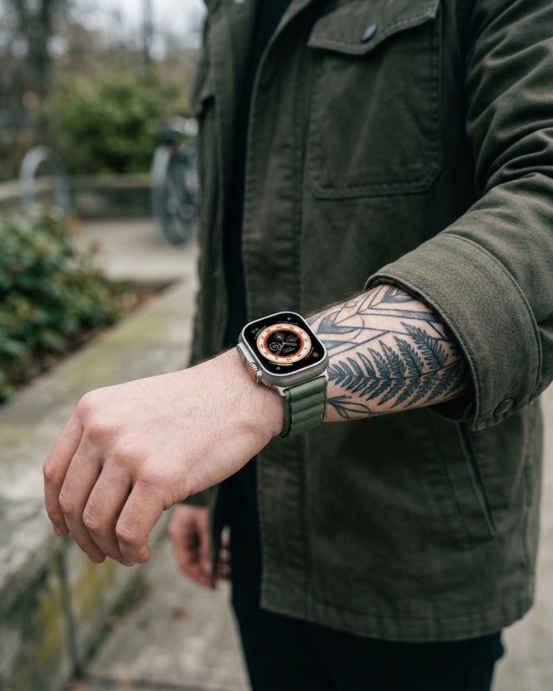 Model wearing Alpine Loop Band For Apple Watch in Green Apple Watch band