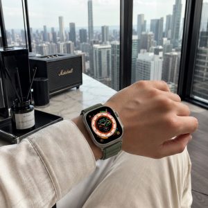 Model wearing Alpine Loop Band For Apple Watch in Green Apple Watch band