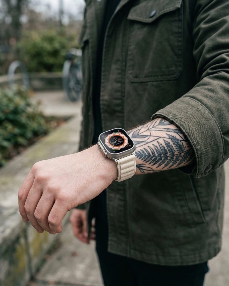 Model wearing Alpine Loop Band For Apple Watch in Starlight Apple Watch band